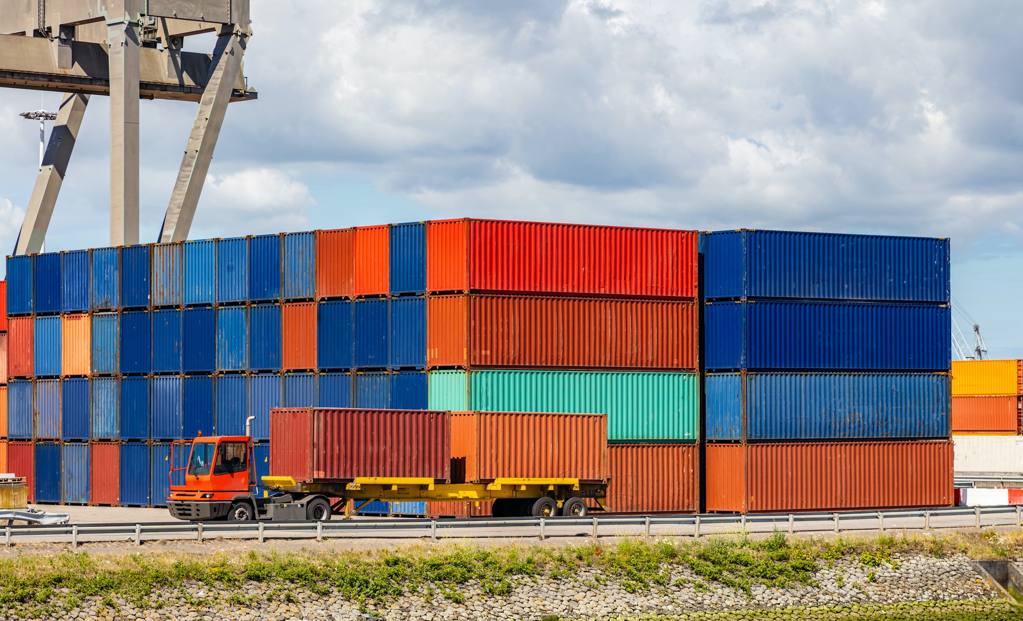 Containers at harbor of Rotterdam, Netherlands. Logistics business, cargo loading unloading