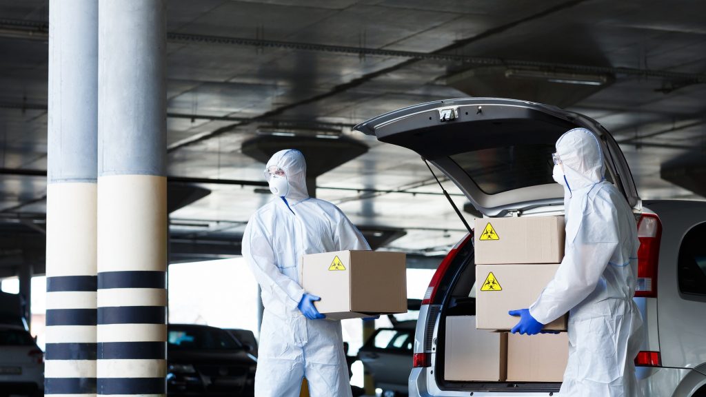 Danger business of trucking, delivering in virus protective suit